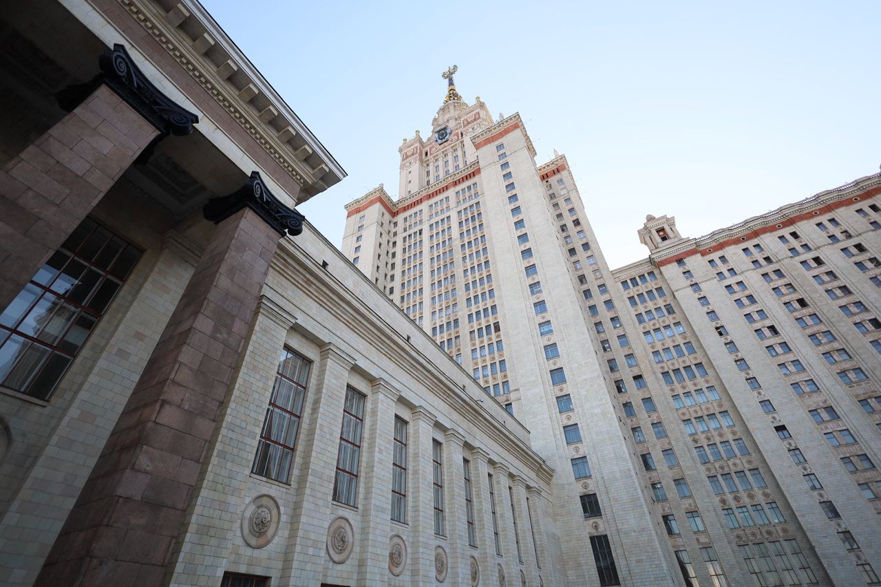View of the iconic Moscow State Universitys Lomonosov Tower against a clear sky.