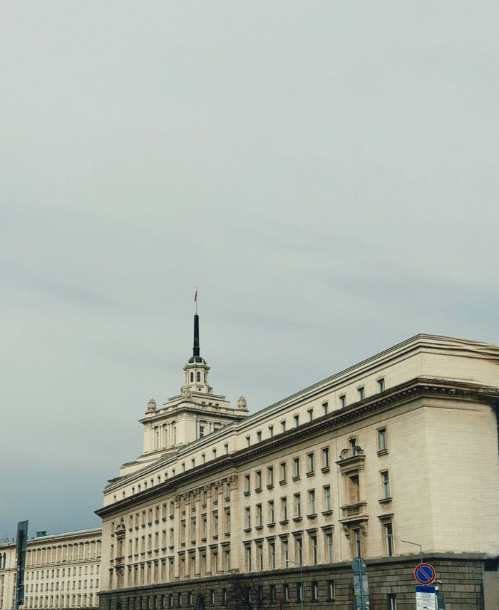 A majestic view of a historic government building in Sofia, Bulgaria, showcasing neoclassical architecture.